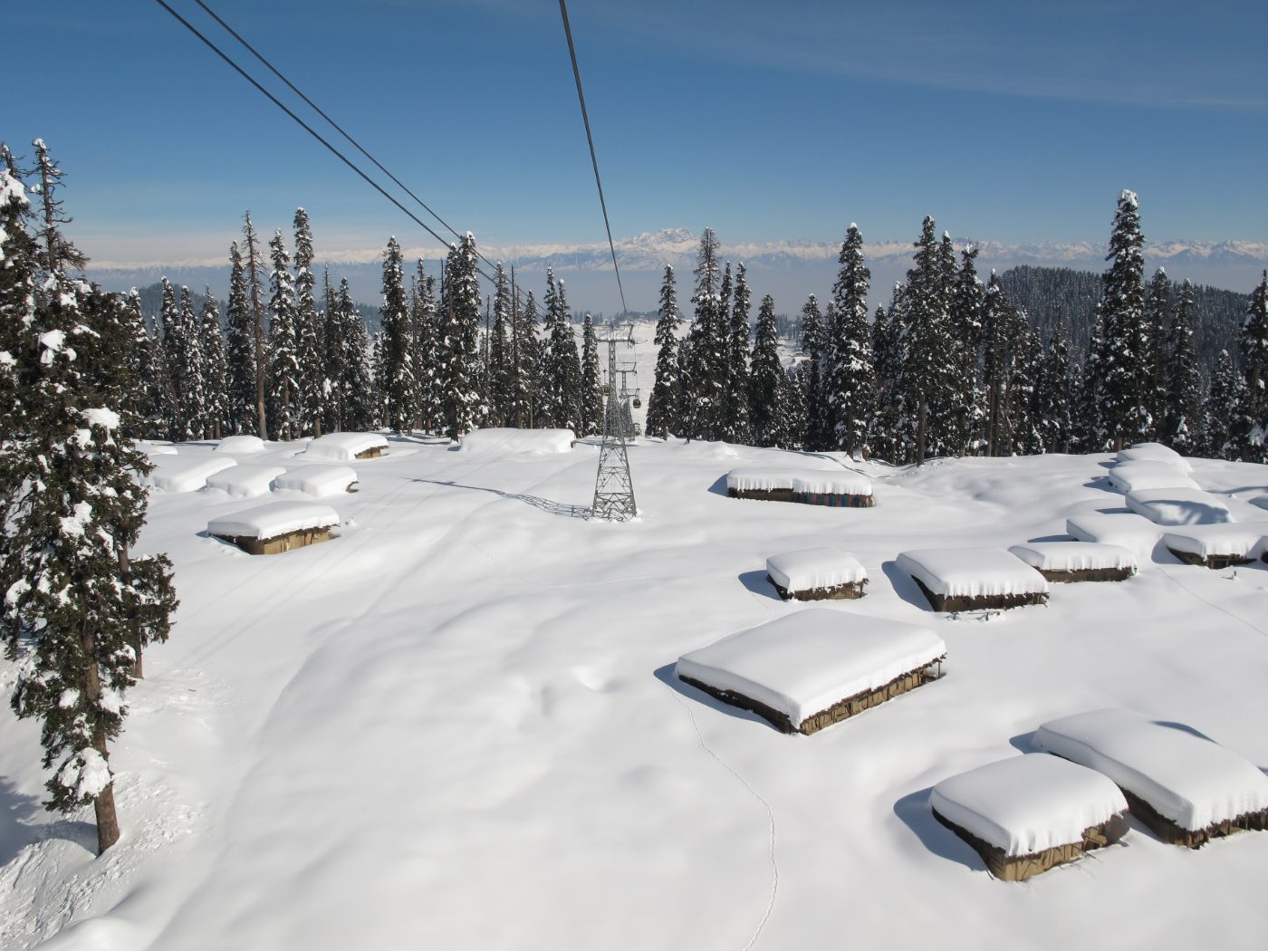 The Gulmarg gondola climbing over snow-covered slopes in Kashmir